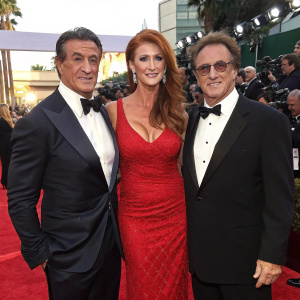 Sylvester Stallone, Angie Everhart, and Frank Stallone at the Golden Globe Awards, wearing elegant evening wear. Red carpet event.