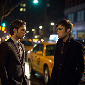 Chace Crawford and Ed Westwick from Gossip Girl, dressed in suits, standing on a busy city street. Darkly lit scene with a yellow taxi in the background.