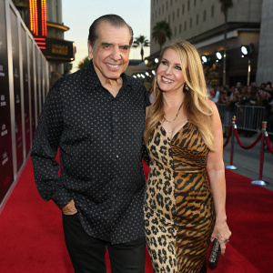 Chazz Palminteri and Gianna Ranaudo, a charming duo, at the premiere event. Chazz in a dark patterned shirt, Gianna in a striking leopard print dress. They smile warmly on the red carpet.