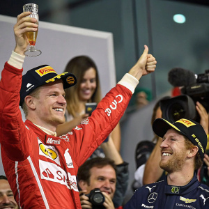Nico Hulkenberg and Sebastian Vettel in a candid moment, celebrating victory in a post-race press conference. Crowd cheering in background.