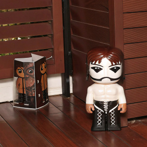 A Funko Pop vinyl figurine of Van Darkholme from a popular culture reference. The box has a Pop logo and price tag. The figurine is displayed outside the box, showcasing its detailed design and likeness to the character. Stylish and cartoonish aesthetic with a muscular build, mask-like face, and leather-like elements. Product photo style.
