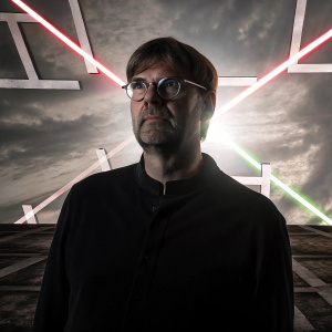 Jurgen Klopp, Liverpool manager, intense stare, glasses, posed for a photo against a chaotic backdrop of intersecting logos and vivid hues.