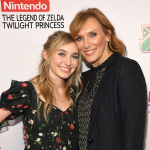 Imogen Poots and Toni Collette posing for a photo at the game launch event. The backdrop features logos of Nintendo and The Legend of Zelda: Twilight Princess.