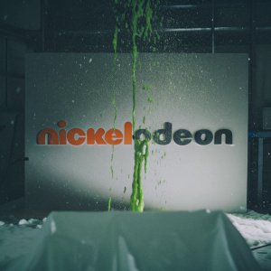 Nickelodeon's iconic logo featuring green gooey slime splashing against a stark white backdrop. Bold, modern font displaying the brand name.