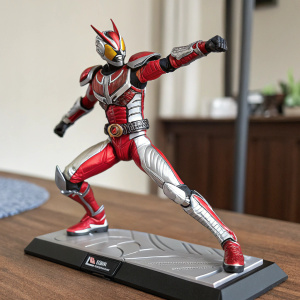 Kamen Rider Ryuki action figure, red and silver. Dynamic pose on display stand. Photo