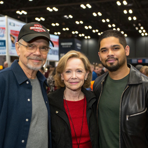 Kurtwood Smith, Debra Jo Rupp, and Wilmer Valderrama at a New York Comic Con panel. Wearing casual clothes, posing for a fan photo.