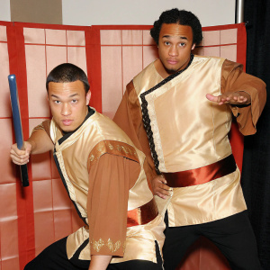Avatar: The Last Airbender characters, Fire Nation soldiers, in action pose. Wearing brown tunics with intricate designs. White studio backdrop