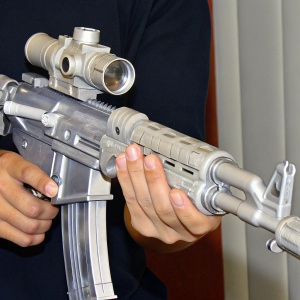 High-resolution render of an AK-47 rifle, gunmetal grey, with all parts clearly detailed.