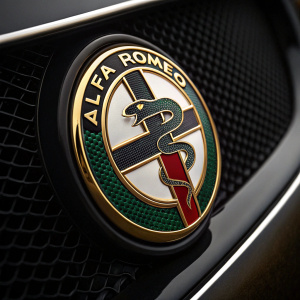 The Alfa Romeo emblem, featuring a green snake and a gold cross. The logo is set against a sleek black background.