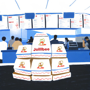 Multiple layers of Jollibee takeaway boxes arranged on a countertop in a bustling fast-food restaurant. Each box is white with red accents and prominently displays the cartoon mascot and brand name.