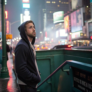 Ryan Gosling standing in front of bustling Times Square, dressed in casual hoodie. Subway entrance backdrop