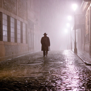 Paco Tous, in a gritty scene from 'Apaches', standing alone in the dark alleys of Madrid. Heavy rain, dim streetlights