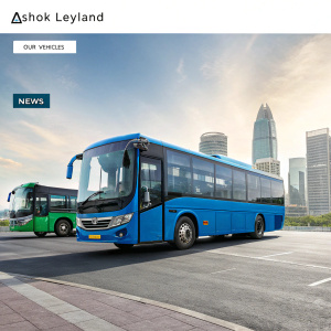 Website showcasing Ashok Leyland vehicles. Large blue bus and small green bus displayed prominently. Sections include 'OUR VEHICLES', 'NEWS', and more. Urban cityscape background.