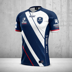 Digital mockup of a sports jersey. Navy blue and white colors, featuring multiple logos and sponsorships. Gray concrete-like background.