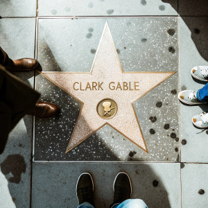 Clark Gable's star on the Hollywood Walk of Fame, photographed from above. Golden star on dark concrete.
