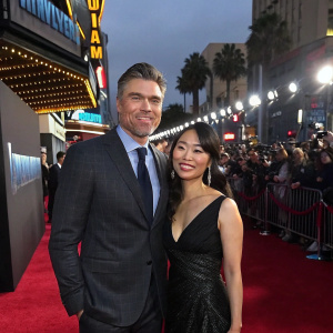 Anson Mount and Darah Trang at the Hollywood premiere of 'Inhumans'. Flashing lights and crowd in background.