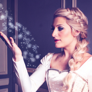 Close-up of Princess Elsa from Disney's Frozen. Emanating magical icy particles from her outstretched hand. Set against a minimalist, icy blue backdrop