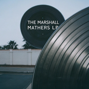 Cover art for Eminem's 'The Marshall Mathers LP'. Modern and sleek design featuring a glossy black record with minimalist text in bold, white font.