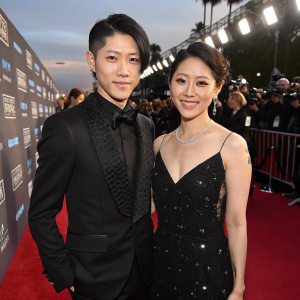 Miyavi and Melody Ishihara on the red carpet at the Critics Choice Movie Awards. The background is bustling with paparazzi and other celebrities