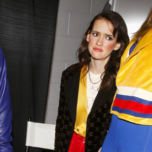 Winona Ryder, close-up. Sad face. Indoor studio setting with plain grey backdrop.