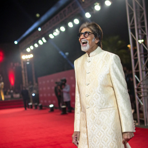 Amitabh Bachchan, dressed in a traditional sherwani, beams with joy at the filmfare awards ceremony.