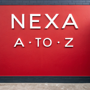 Bold NEXA font showcased against vivid red backdrop. Alphabet displayed from A to Z, each letter distinct, graphic style.