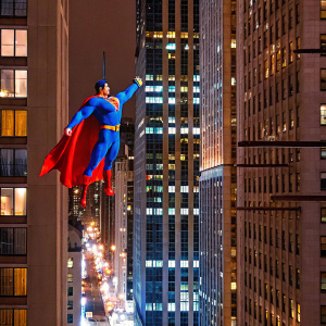 DC Comics superhero, Superman, leaping off a skyscraper in a bustling cityscape. Gotham's skyline, vibrant and detailed.