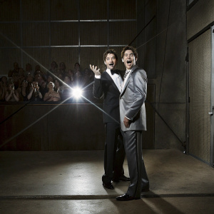 JC Chasez and Dallas Austin, both in formal attire, at an award ceremony. Glowing stage lights, crowd visible