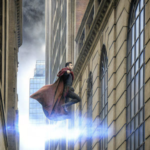 Benedict Cumberbatch in action scene from Doctor Strange. Dressed in red cloak, dramatic cityscape background