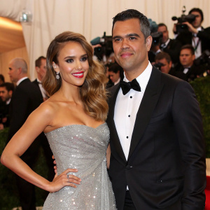 Jessica Alba and Cash Warren at the Met Gala. Jessica wears a sparkling silver dress. Cash in black tuxedo.