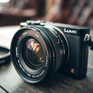 Detailed macro shot of the Lumix DMC LX100 camera. Focusing on the Leica-branded lens.