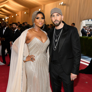 Toni Braxton and Eminem at the Met Gala. Braxton in a glamorous gown, Eminem in a suit. Crowded venue, vibrant ambiance, star-studded event.