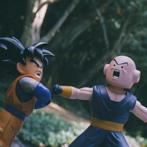Colorful animated scene featuring Goku and Vegeta in a fierce battle. Majin Buu as the antagonist. Dynamic action poses, expressive faces, and vibrant colors. Studio Ghibli style.