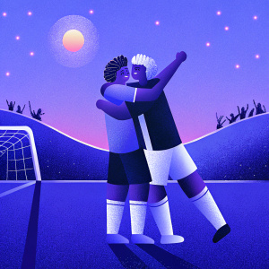 Erik Lamela and a teammate in a joyous hug post-goal celebration on a sunny soccer field.