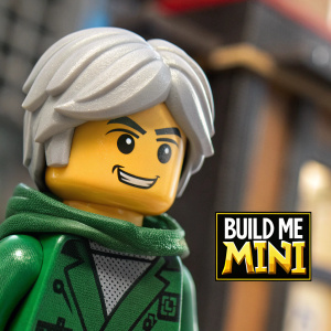 Close-up image of Lloyd Garmadon, the Lego Ninjago Movie character. Gray hair, green hooded jacket, friendly expression. Promotional text for Build Me Mini series on side