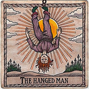 Tarot card The Hanged Man, hanging at full height upside down, head against the background of the sun, at the bottom the inscription: The Hanged Man