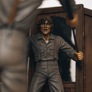 Roger Sánchez March's portrayal of Alex Delarge from 'A Clockwork Orange'. Dramatic pose, gray outfit, brown accessory. Empty white backdrop