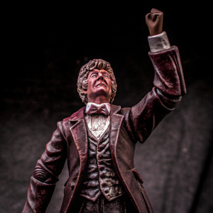 3D render of The Third Doctor from Doctor Who. Wearing a red velvet jacket, white shirt, and bow tie. Stands in a dramatic pose with a stern expression on a dark gray background