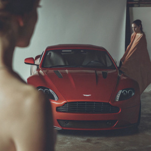 Luxury sports car, Aston Martin V12 Vantage S Coupe, center stage. High gloss finish, sharp angles. Empty white studio space. Professional photography setup