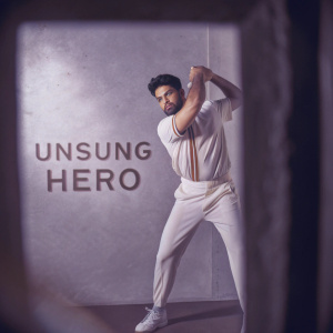 Virat Kohli, Indian cricket star, in a vibrant color photo shoot. Labeled 'Unsung Hero'.