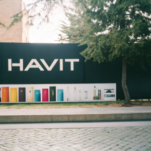 HAVIT, an Indian tech brand, in a sleek promotional photo. Modern design concept with vibrant packaging and labeling ideas. Against a bold black backdrop, the HAVIT logo in modern sans-serif font at the forefront.