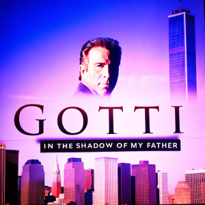 John Travolta starring in Gotti: In the Shadow of My Father. Movie poster featuring cityscape backdrop with skyscrapers. Travolta's face prominently displayed with cast names and movie title.