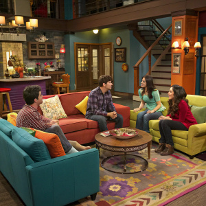 A lively scene from Wizards of Waverly Place. Modern living room, filled with vibrant colors and cozy furniture. Cast members gathered around