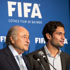 Joseph S. Blatter and Raul Gutierrez in a press conference. Blue backdrop with FIFA logo