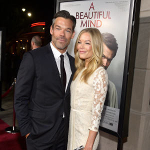 Eddie Cibrian and LeAnn Rimes at an exclusive film premiere. Movie poster of 'A Beautiful Mind' in background.