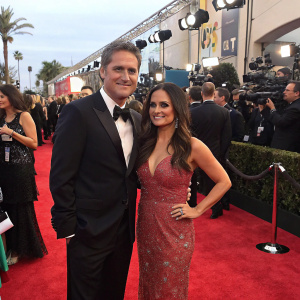 Scott Sveslosky and Danica McKellar attend a star-studded gala. Red carpet event with flashing cameras