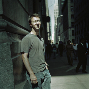 Edward Norton, in a candid shot, sporting a casual outfit. Jeans and t-shirt. Urban street scene
