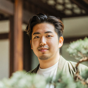 professional headshot of a young japan man natural lighting confident and approachable expression blurred background soft depth of field modern yet casual look