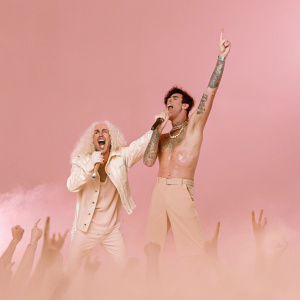Black Veil Brides performing live. Dee Snider, with curly white hair, and Andy Biersack, with dark styled haircut, in energetic pose. Crowded concert venue