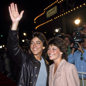 Scott Baio and Erin Moran at the 'Joanie Loves Chachi' premiere event. Bright lights and paparazzi in the background